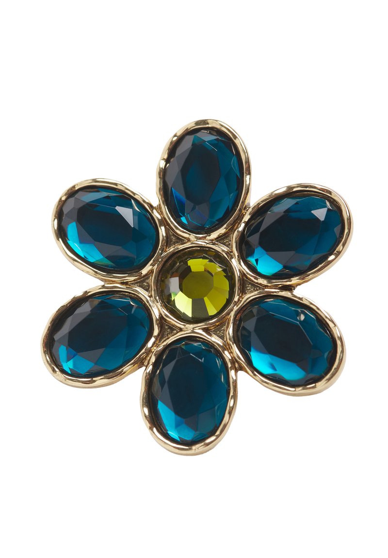 Broche en forme de fleur en or avec six grandes pierres précieuses ovales bleues comme pétales et une pierre précieuse ronde jaune au centre.