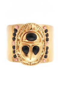 Gold-tone ring featuring a large oval black stone centerpiece, intricate detailing around edges, and smaller black stones along the band.