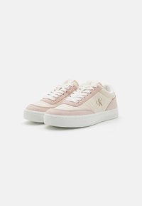Pink and white low-top sneakers made from leather and canvas, featuring white laces, subtle branding, and a textured rubber sole.