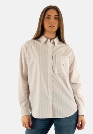 Camicia button-up a righe in beige e bianco, con taschino sul petto, colletto punta e maniche lunghe con polsini abbottonati.