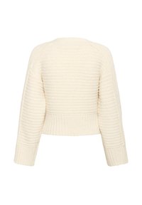 Kreemjas, lühendatud sviiter ribatekstuuriga, millel on pikad varrukad ja lai ümmargune kaelus. Pehme, kudumisest valmistatud kangas, millel on peened horisontaalsed triibud.