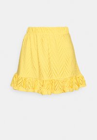 Geel rokje met een elastische tailleband, textuurstof met uitgesneden patronen en een rimplhem aan de onderkant.