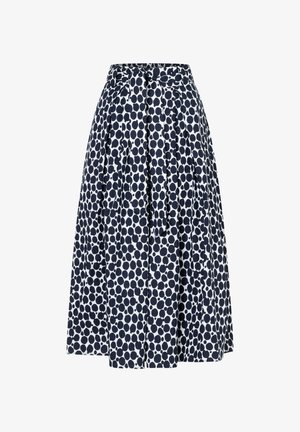 Jupe bleu marine à pois blancs avec un design évasé, comprenant des plis et un détail de nœud à la taille. Tissu léger, longueur au genou.