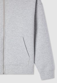 Felpa grigia con zip realizzata in tessuto morbido, dotata di tasca frontale e polsini a coste. La texture è liscia con un leggero motivo melangiato.