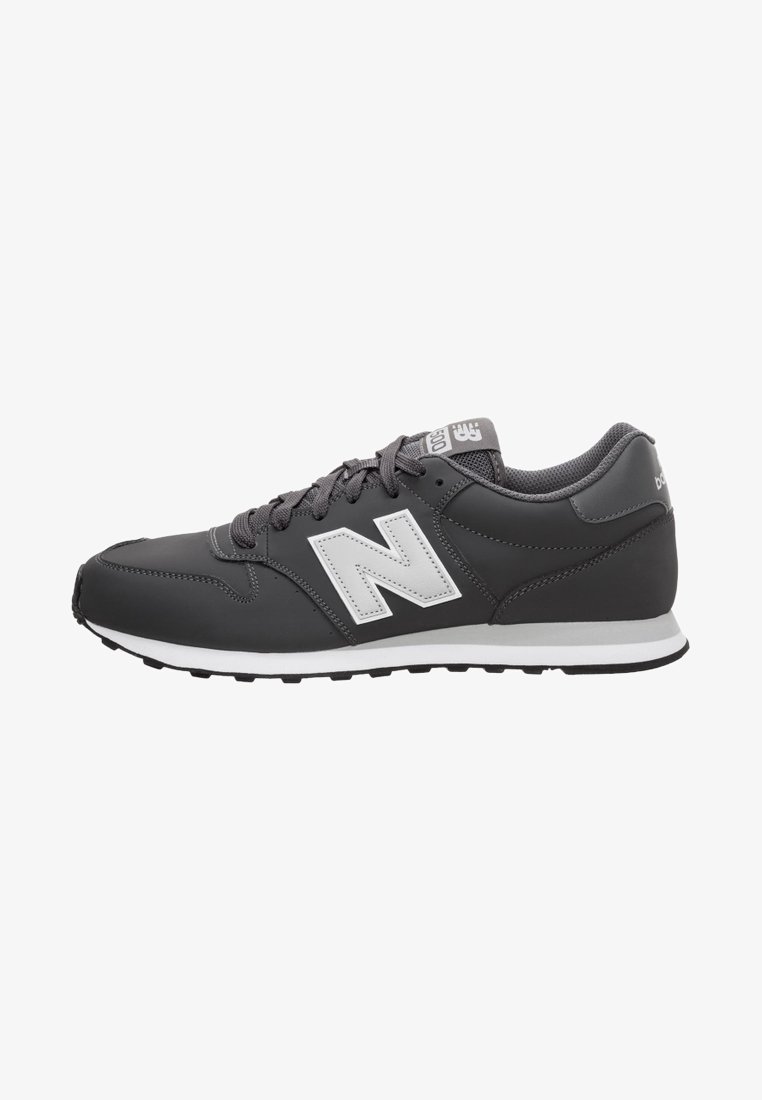 Black synthetic athletic shoe with gray accents, featuring a prominent white "N" logo on the side, lace-up design, and textured sole.