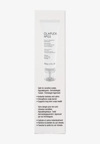 Olaplex No. 0.5 hoofdhuidbehandeling in witte tube met doorzichtige nozzle. De tekst bevat tweetalige productdetails en informatie over allergenen op een lichte achtergrond.