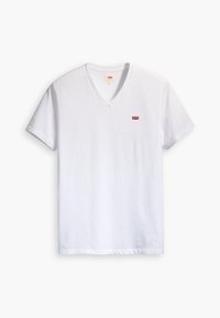 T-shirt en coton blanc à col en V avec un petit logo rouge sur la poitrine gauche. Coupe décontractée avec des manches courtes et un ourlet droit.