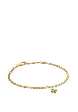 Gold chain bracelet with a small four-leaf clover charm featuring green gemstone petals and a lobster clasp closure.