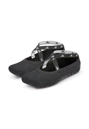 Black slip-on shoes with a textured finish, featuring crisscross elastic straps and a flexible sole. Designed for comfort and ease of wear.