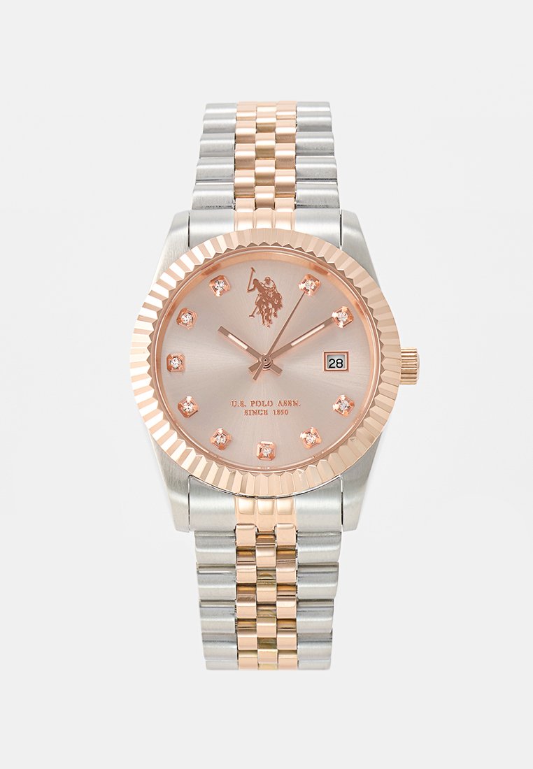 Montre ronde avec une lunette en or rose et un bracelet en acier inoxydable argenté et or rose. Dotée d'un cadran gris clair, d'un affichage de date et de marqueurs en cristal.