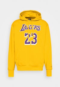 Sweat à capuche jaune en coton avec une poche avant. Inscription "LAKERS" en violet et "23" en blanc et violet sur la poitrine. Capuche ajustable.