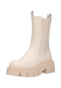 Stivale alla caviglia beige con suola chunky, pannelli laterali elastici e linguette posteriori, texture in pelle liscia e suola scanalata per una migliore aderenza.