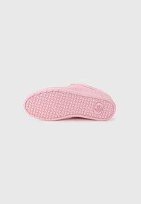 Pink sneaker sole with textured, patterned grip, featuring a smooth, rounded toe and a logo emblem on the side.
