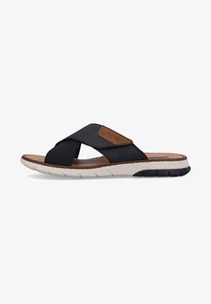 Black slide sandal with cross-strap design, featuring textured fabric and brown faux leather accents. White midsole with treaded black outsole.