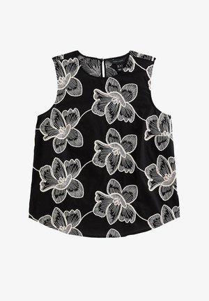 Zwarte mouwloze top met grote witte bloemrijke borduurwerk en een kleine ritssluiting aan de achterkant.