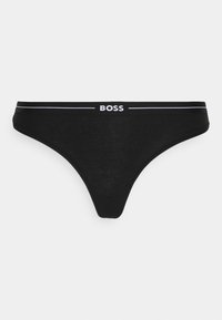 Čierne tangá s širokým elastickým pásom s bielym logom "BOSS" a hladkým, bezšvovým dizajnom.