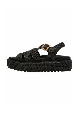Sandali platform neri con cinturini intrecciati superiori e un'accattivante fibbia. Suola texturizzata con una robusta base intrecciata, che offre un'altezza significativa.