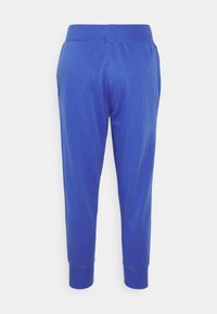 Blå sweatpants i en bomullsblandning, med ett åtsittande midjeband, tapered bendesign och ribbade mudd vid anklarna.