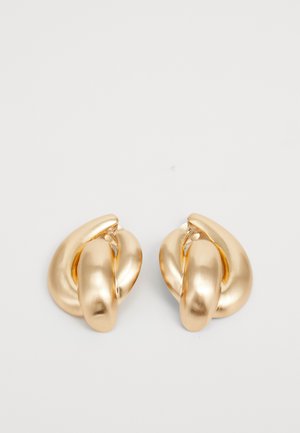 Gold-tone metal earrings featuring a twisted design with a smooth, shiny surface and rounded shapes. Each measures approximately 2 inches.