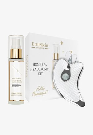 Eliksir serum z kwasem hialuronowym i kolagenem w przezroczystej szklanej butelce z złotymi akcentami, połączony z srebrnym narzędziem do pielęgnacji skóry w białym pudełku.