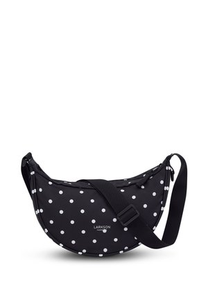Black crescent-shaped crossbody bag with white polka dots, adjustable black strap, zipper closure, and small "Larkson Hamburg" logo.
