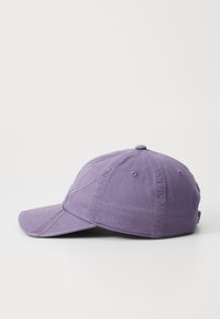 Purple cotton baseball cap with a curved visor, stitched details, and a button on top. Features ventilation holes and an adjustable strap.