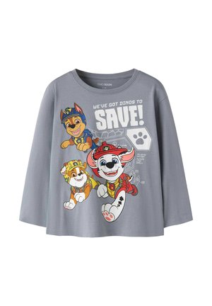Grå langærmet børneskjorte med tre tegneserie-hvalpe i redningsudstyr og teksten "We've got dinos to save!" på forsiden.