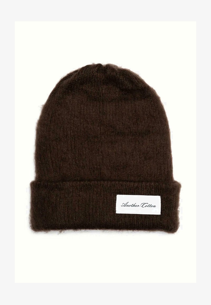 Csokoládébarna kötött sapka puha gyapjúból, hajtogatott peremmel és oldalon fehér márkajellel. Texturált felület.