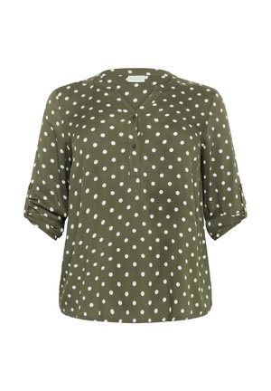 Olive green blouse with white polka dots, V-neckline, and button placket. Features rolled sleeves and a smooth fabric texture.