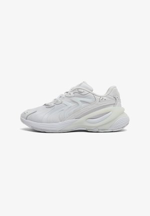 Athletic shoes in white mesh and synthetic material, featuring a rounded toe, textured accents, and a cushioned sole with a wavy design.