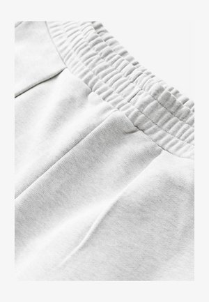 Šedé bavlnené tepláky s elastickým pásom, s bočnými vreckami a mäkkou, textúrovanou tkaninou pre pohodlie.