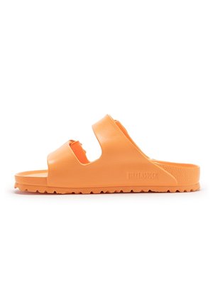 Orange slip-on sandal with two wide straps, textured sole, and Birkenstock branding on the side, shown from a side profile.