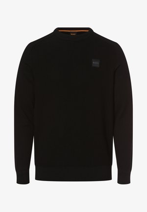 Black knitted sweater with a crew neckline, featuring a square logo patch and textured design. Cuffs and hem are ribbed.