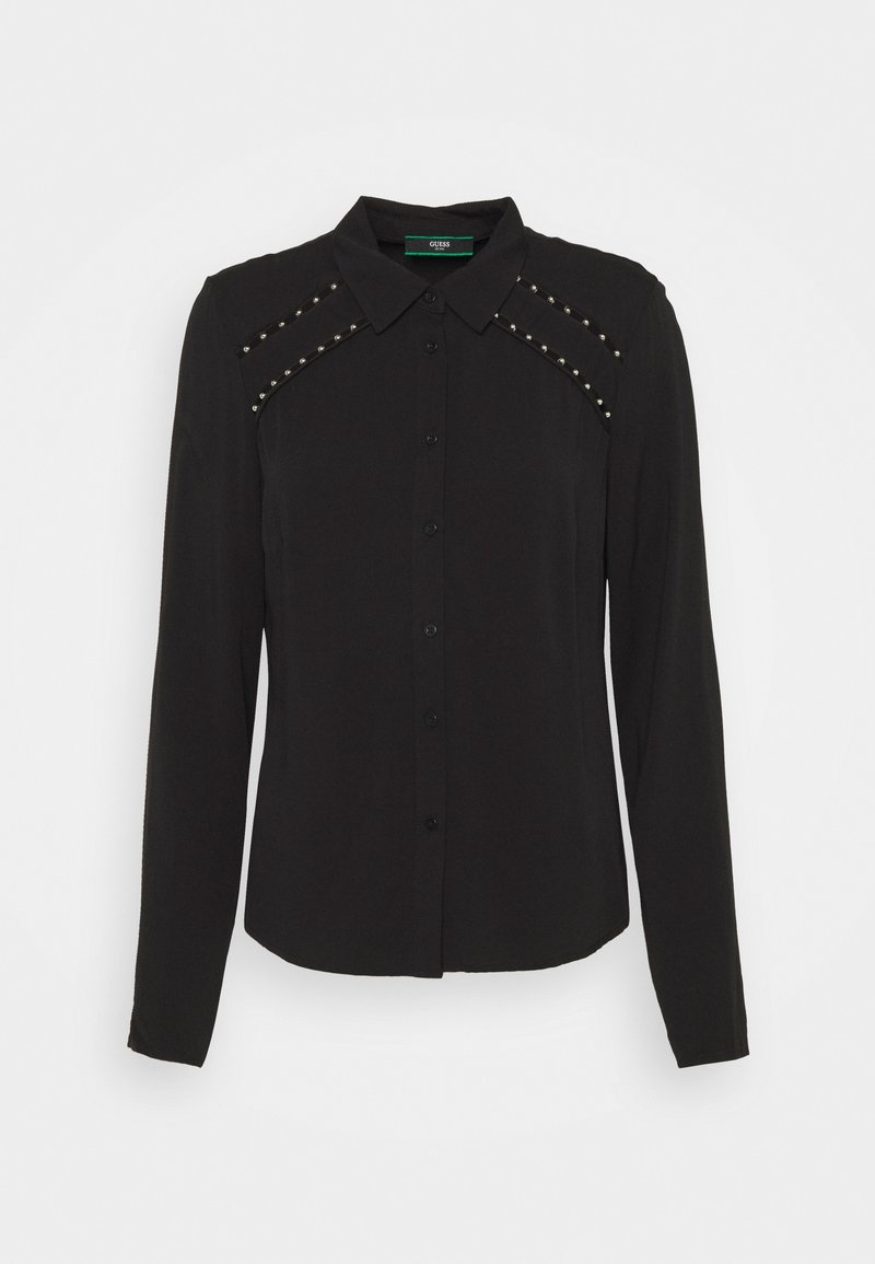 Chemise noire à manches longues avec boutons, col pointu et détails de clous argentés le long du haut de la poitrine et des coutures d'épaules.