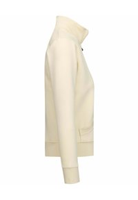 Giacca zip-up color crema con colletto alto, maniche lunghe e tasche laterali. Tessuto liscio e design minimalista senza motivi.