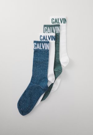 Three pairs of socks: one dark blue, one dark green, and one white, all featuring ribbed texture and contrasting "CALVIN" branding on the cuffs.