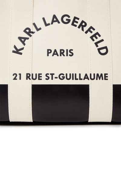 Черна и бяла платнена чанта със ситопечат "KARL LAGERFELD PARIS 21 RUE ST-GUILLAUME" отпред.