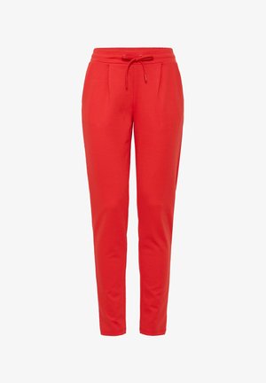 Joggers en coton rouge avec une taille élastique, un cordon de serrage et deux poches latérales. Conçus avec une jambe fuselée et une texture douce.