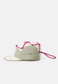 Cappello con un frontale beige, lati in tessuto grigio e design con cordino rosa. Presenta una visiera curva e un materiale testurizzato.