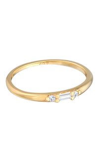 Guldring med en glat, afrundet skede, der har en central rektangulær sten og to runde sten på hver side; minimalistisk design.