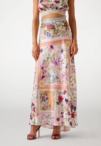 Long floral skirt featuring a pastel color palette with intricate patterns, layered design, flowing fabric, and a slight train.