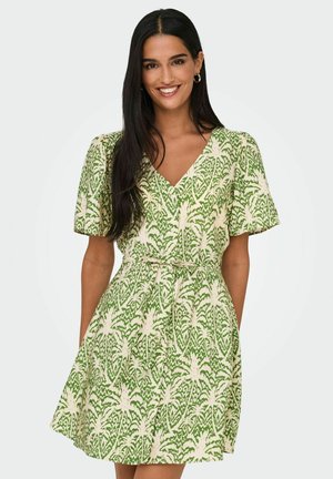 Vestito corto verde e crema con motivi floreali, scollo a V, maniche corte e vita con lacci, realizzato in tessuto leggero.
