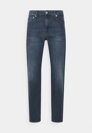 Marinblå denimjeans med rak bendesign, med framfickor, dragkedja och medelhög midja. Diskret blekning finns.