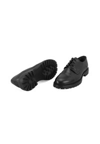 Schwarze Leder-Schuhe mit einer runden Zehenpartie, Schnürdesign und strukturiertem Gummisohle mit aggressiven Profil für Grip und Stabilität.