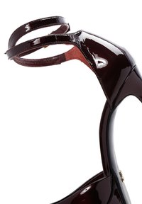 Burgundy patent leather high-heeled sandal with a slender ankle strap, pointed toe, and a smooth, glossy finish. Minimal hardware detail.