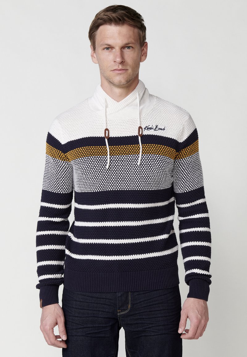 Jersey de punto a rayas en azul marino y blanco con capucha, que presenta rayas horizontales en acentos amarillos y marrones. Tejido texturizado y puños de canalé.
