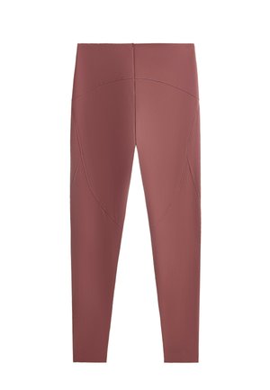 Leggings taille haute mauve avec des détails de coutures visibles autour des hanches et des cuisses, fabriqués en tissu lisse et extensible.