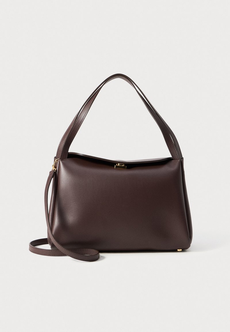 Brown leather handbag with a structured shape, featuring a single top handle and a detachable shoulder strap. Gold-tone hardware detail.