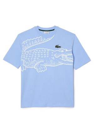 T-shirt bleu clair à manches courtes avec un grand dessin au trait blanc représentant un crocodile et un petit logo crocodile vert sur la poitrine.