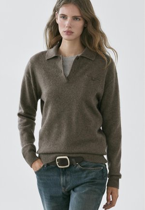Brown wool sweater with a collared neckline, three-button placket, and ribbed cuffs. Paired with blue jeans and a black belt.